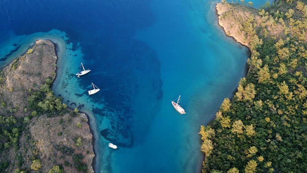 aerial view of white boat on blue sea water during daytime